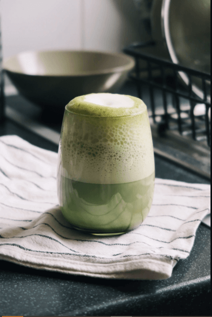 Hot protein matcha latte with frothy green foam