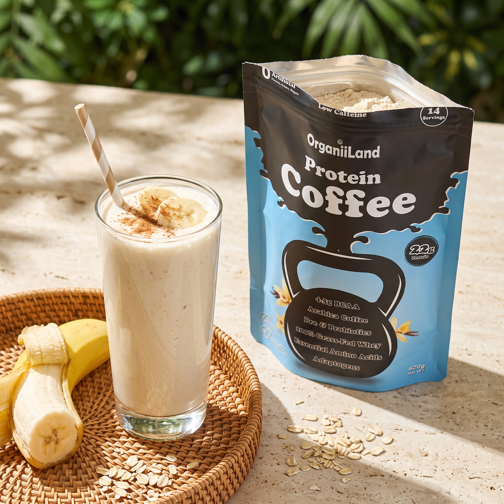 Thick vanilla protein shake with banana on a travertine patio table beside an opened OrganiiLand French Vanilla Protein Coffee bag