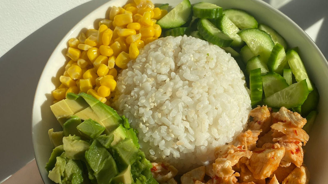 A balanced poke bowl with rice, avocado, corn and protein, a post-workout meal