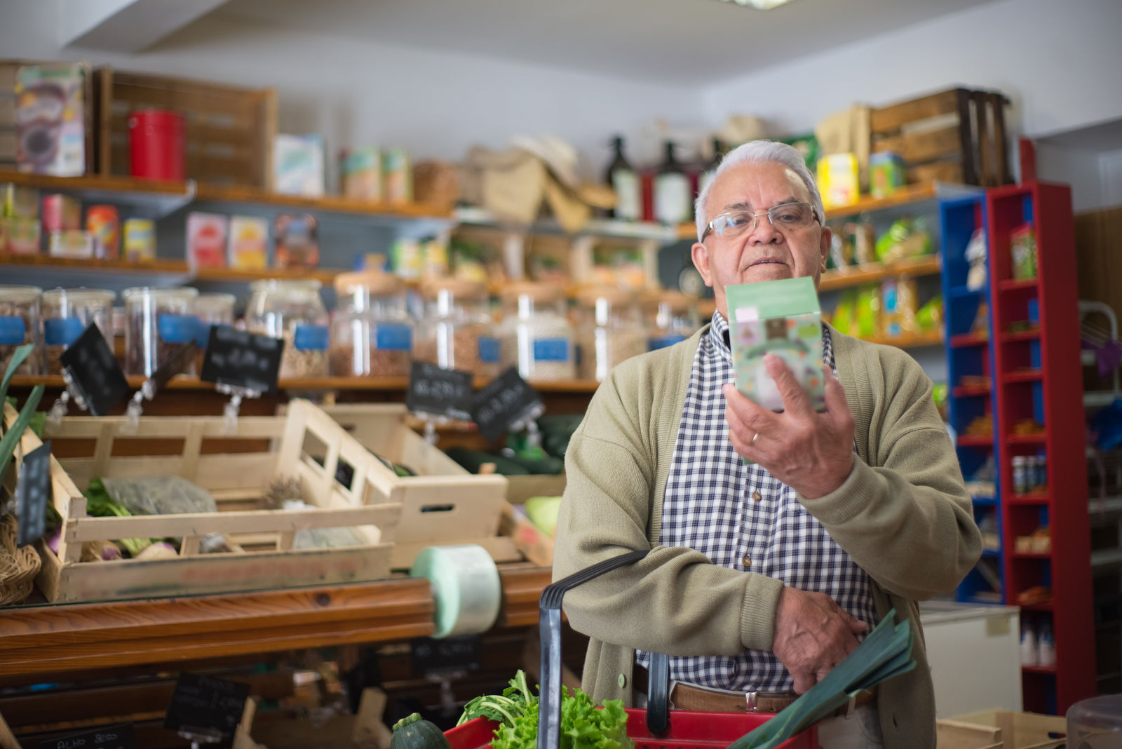 A shopper reading the ingredient label on a product